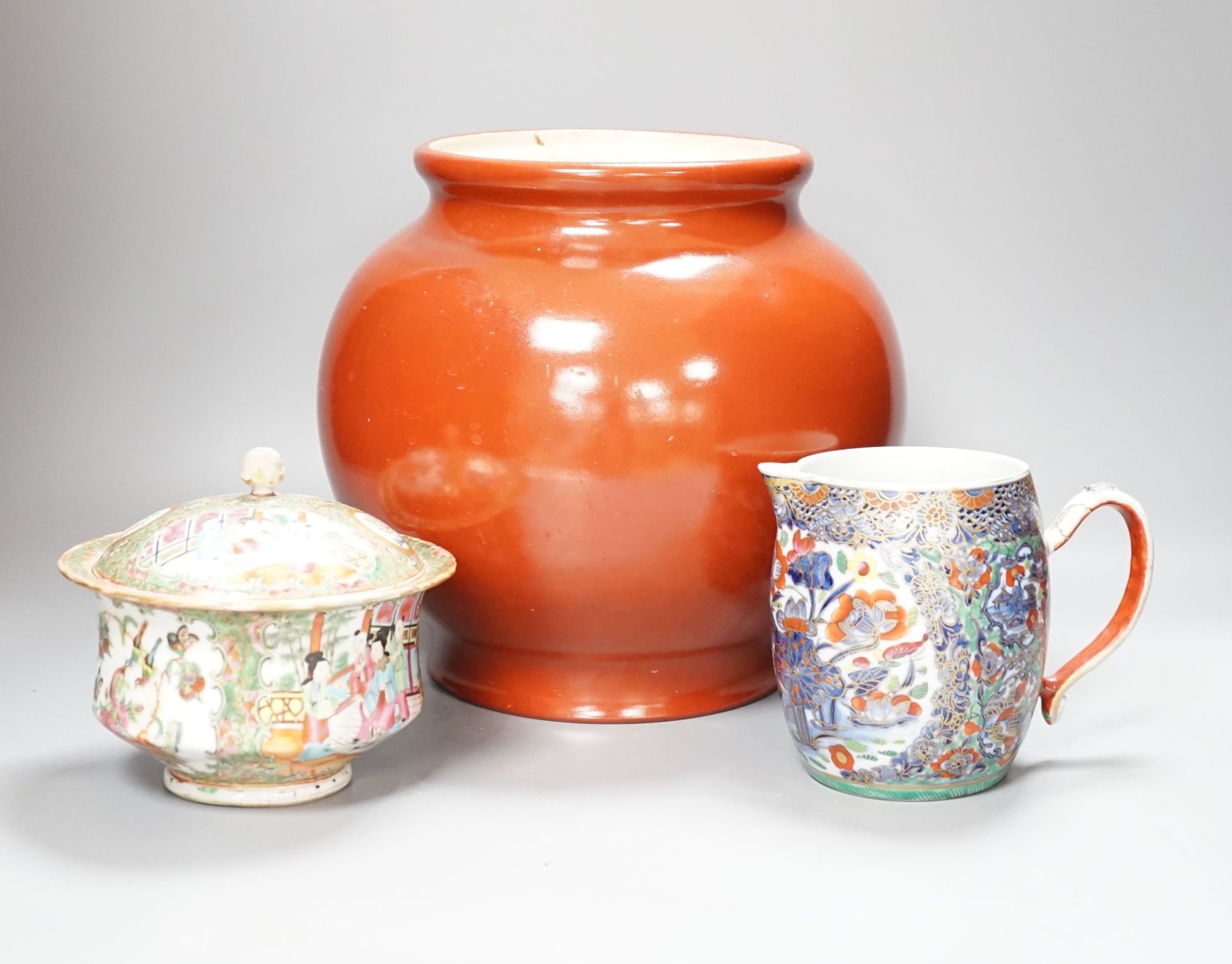 A 19th century Chinese famille rose pot and cover, 15cm diam., together with a decorative Chinese jug and large monochrome china pot
